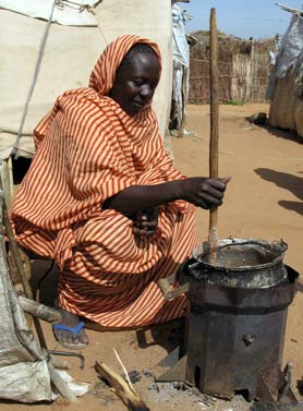 Darfur stove in use by Halima